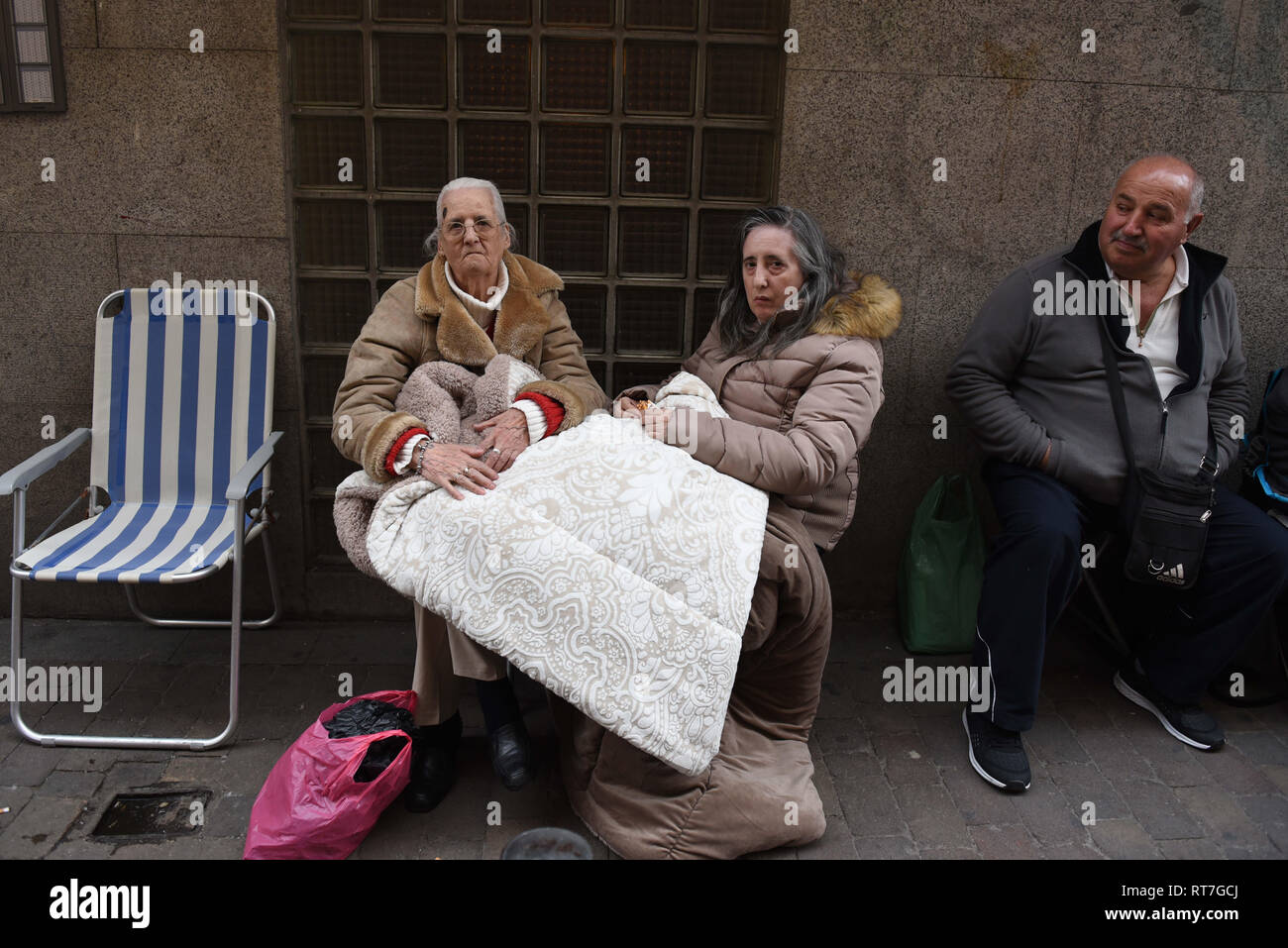 Madrid, Madrid, Spain. 28th Feb, 2019. Faithful followers seen waiting in queue in the street for the first Friday.Thousands of Catholics from various countries gathered close to the 'JesÃºs de Medinaceli' church in Madrid on the first Friday of March, Friday of Lent, to kiss the right foot of a 17th-century wooden image of Christ, known as Christ of Medinaceli. Pilgrims make three wishes to Jesus, of which he is said to grant one. Credit: John Milner/SOPA Images/ZUMA Wire/Alamy Live News Stock Photo