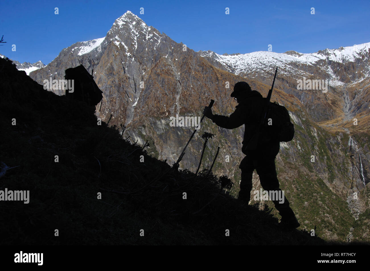 silhouette of hunter in  South Westland's Southern Alps, New Zealand Stock Photo
