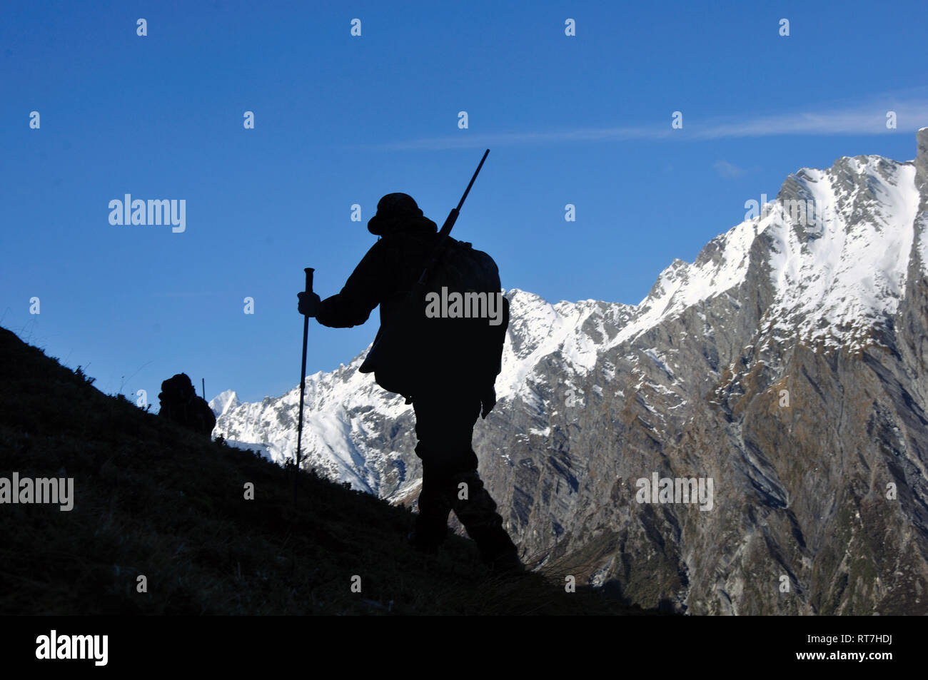silhouette of hunter in  South Westland's Southern Alps, New Zealand Stock Photo