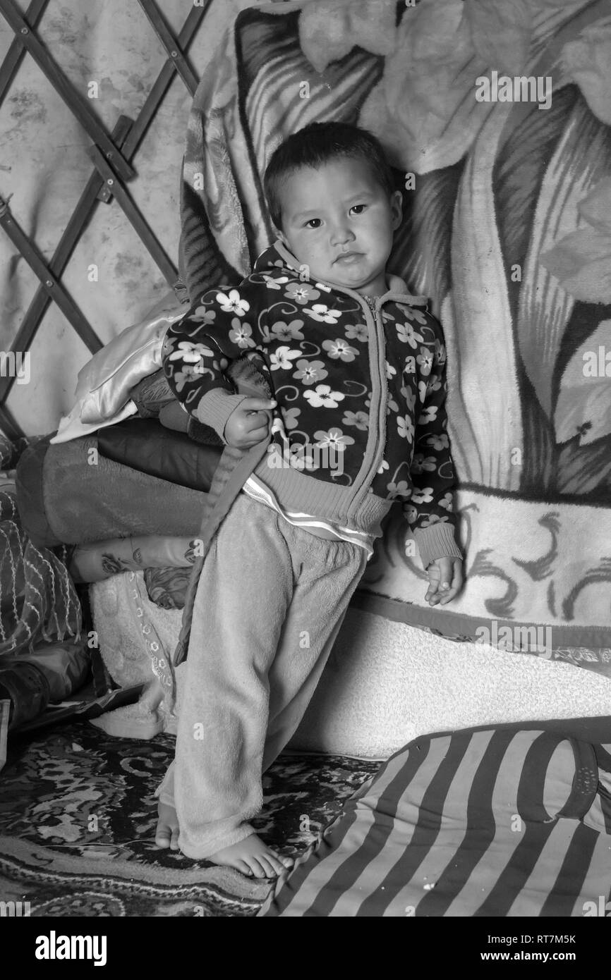 Portrait of a young boy in a herding family's yurt, Assy Plateau, Kazakhstan Stock Photo