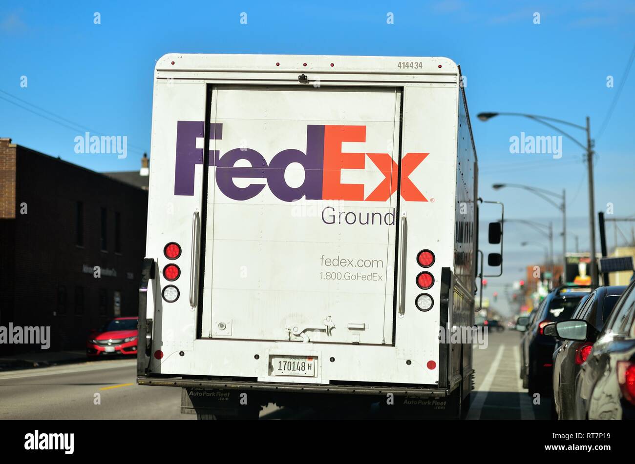 Chicago, Illinois, USA. Federal Express Ground delivery truck double parked on a city street. Stock Photo