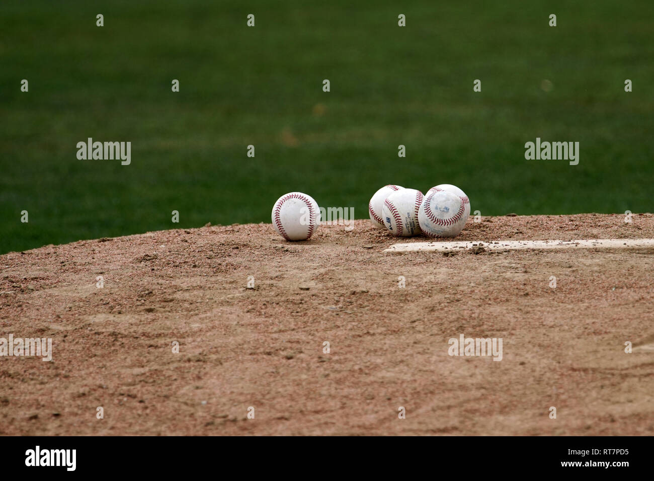 A pile of baseballs on the pitchers mound Stock Photo Alamy