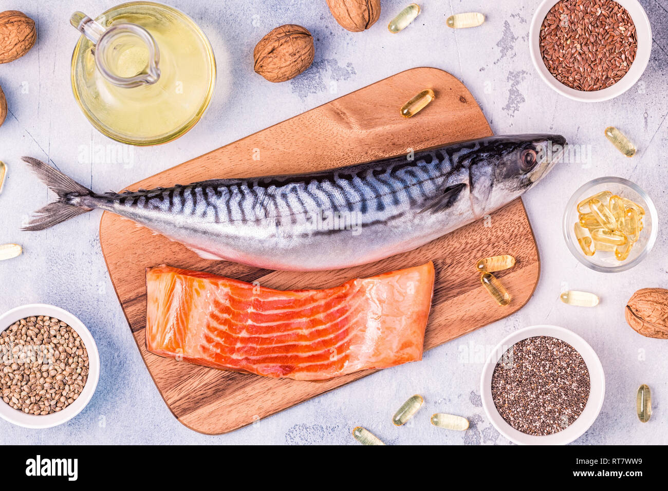 Sources of omega 3 - mackerel, salmon, flax seeds, hemp seeds, chia, walnuts, flaxseed oil. Healthy eating concept. Top view with copy space. Stock Photo