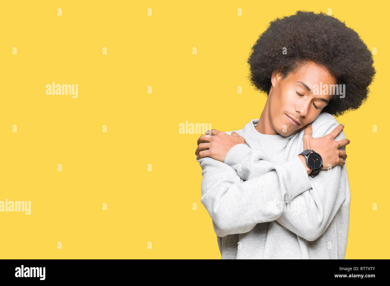Young African American Man With Afro Hair Wearing Sporty Sweatshirt Hugging Oneself Happy And Positive Smiling Confident Self Love And Self Care Stock Photo Alamy