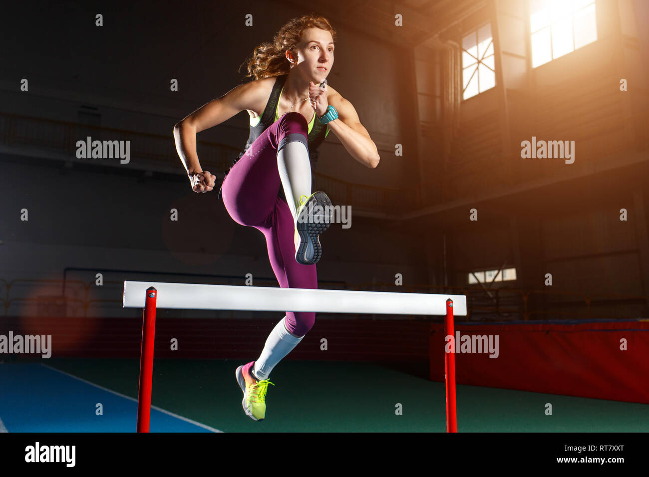 Runner jumping a hurdle hires stock photography and images Alamy