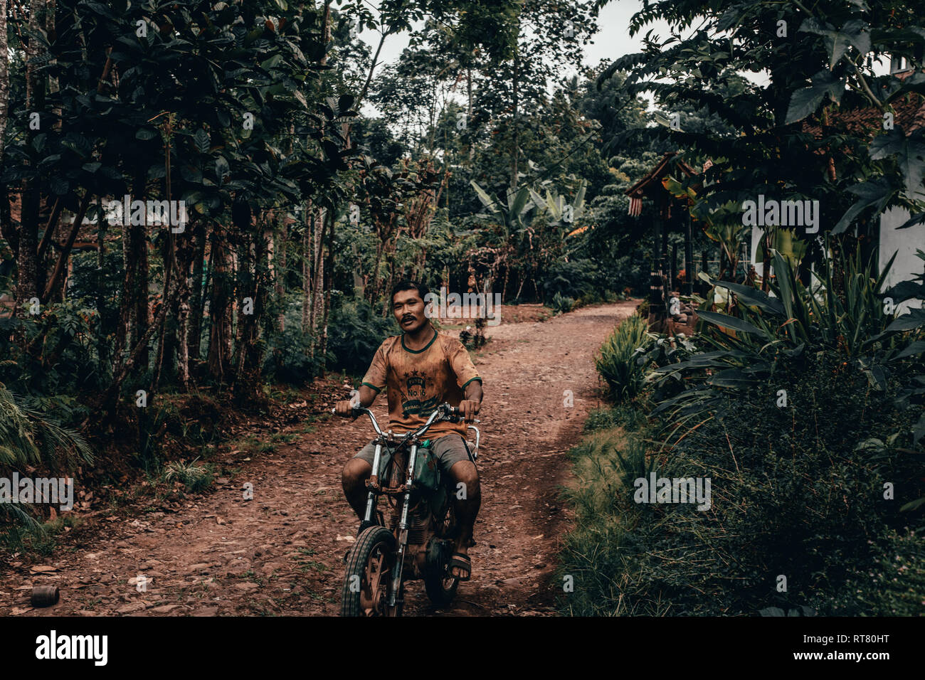IJEN, INDONESIA - Nov 17, 2018: An Indonesian man riding a motorcycle ...