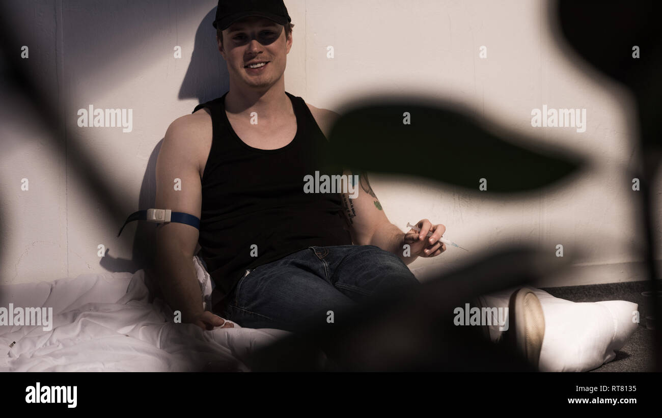 selective focus of junkie man smiling under influence of narcotic Stock Photo Alamy