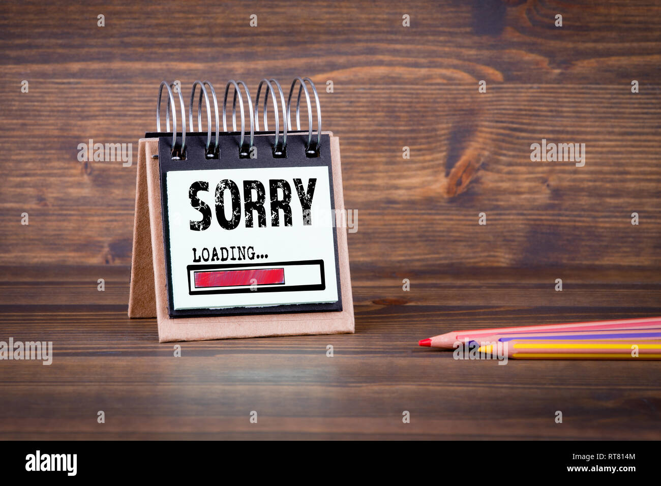 Sorry, loading concept. Dark wooden office table Stock Photo - Alamy