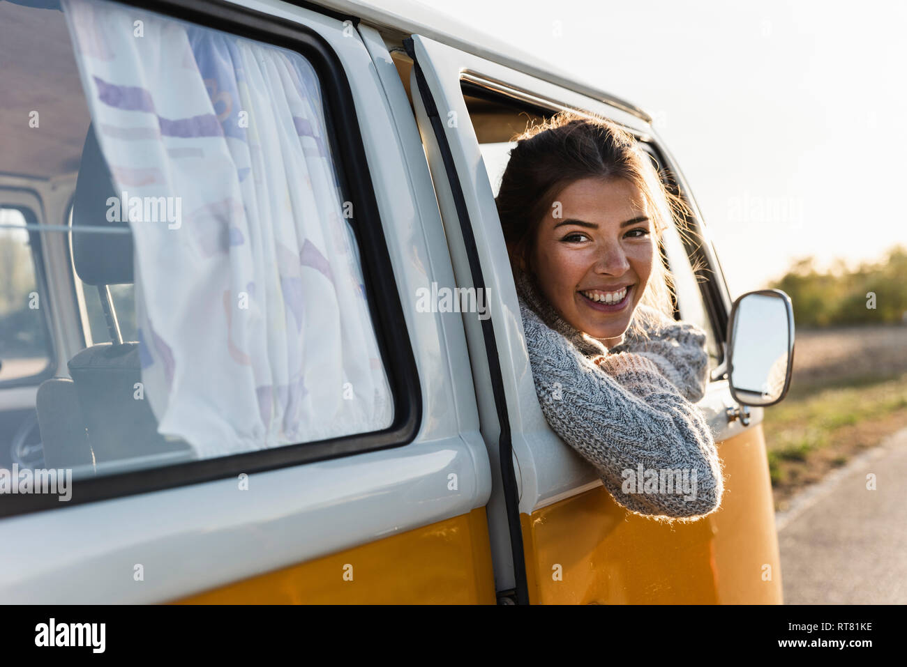 Pretty woman on a road trip with her camper Stock Photo - Alamy