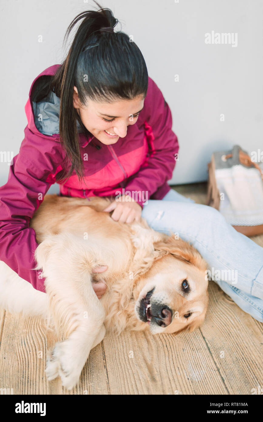 Woman playing with golden retriever hi-res stock photography and images ...