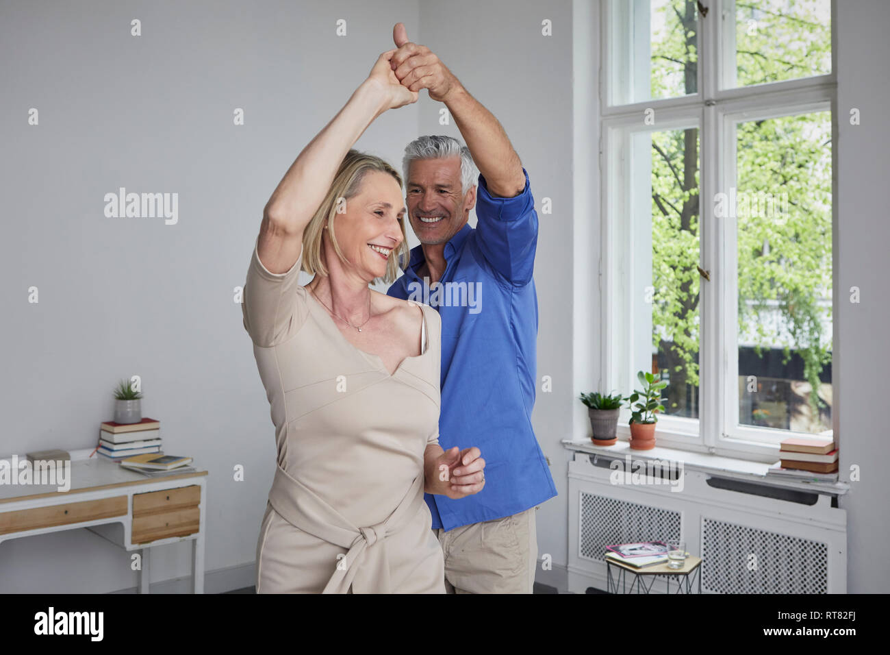 Happy mature couple dancing at home Stock Photo