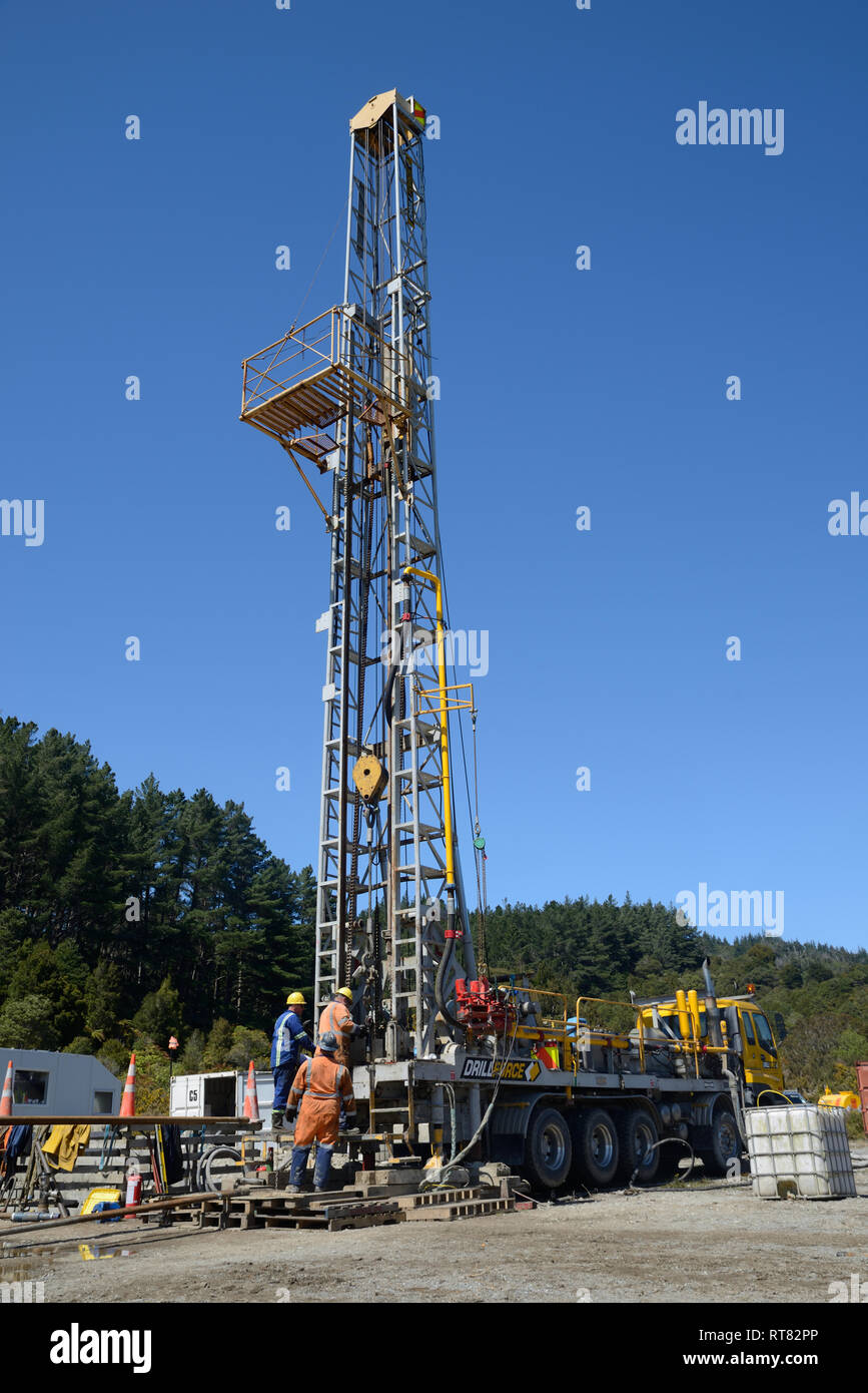 DOBSON, NEW ZEALAND, OCTOBER 13, 2018: Engineers feed the drill string down an old gas well in preparation for capping the well. Stock Photo