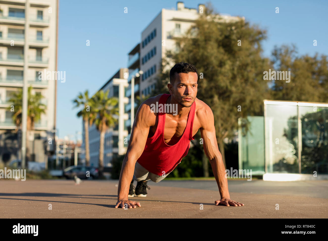Muscular man doing pushups in the city Stock Photo - Alamy
