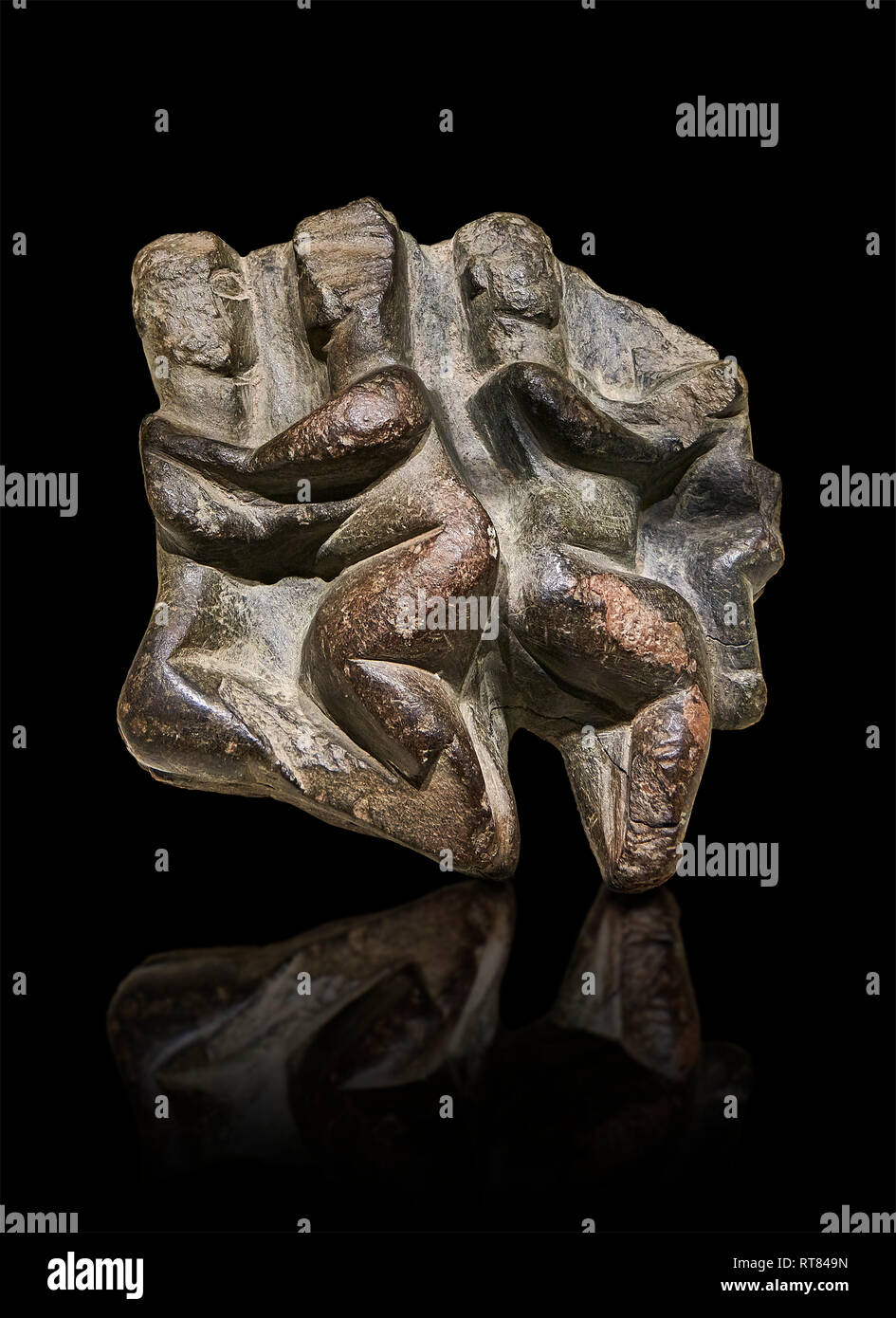 Stone relief of four figures. Catalhoyuk Collections. Museum of Anatolian Civilisations, Ankara. Against a black background Stock Photo