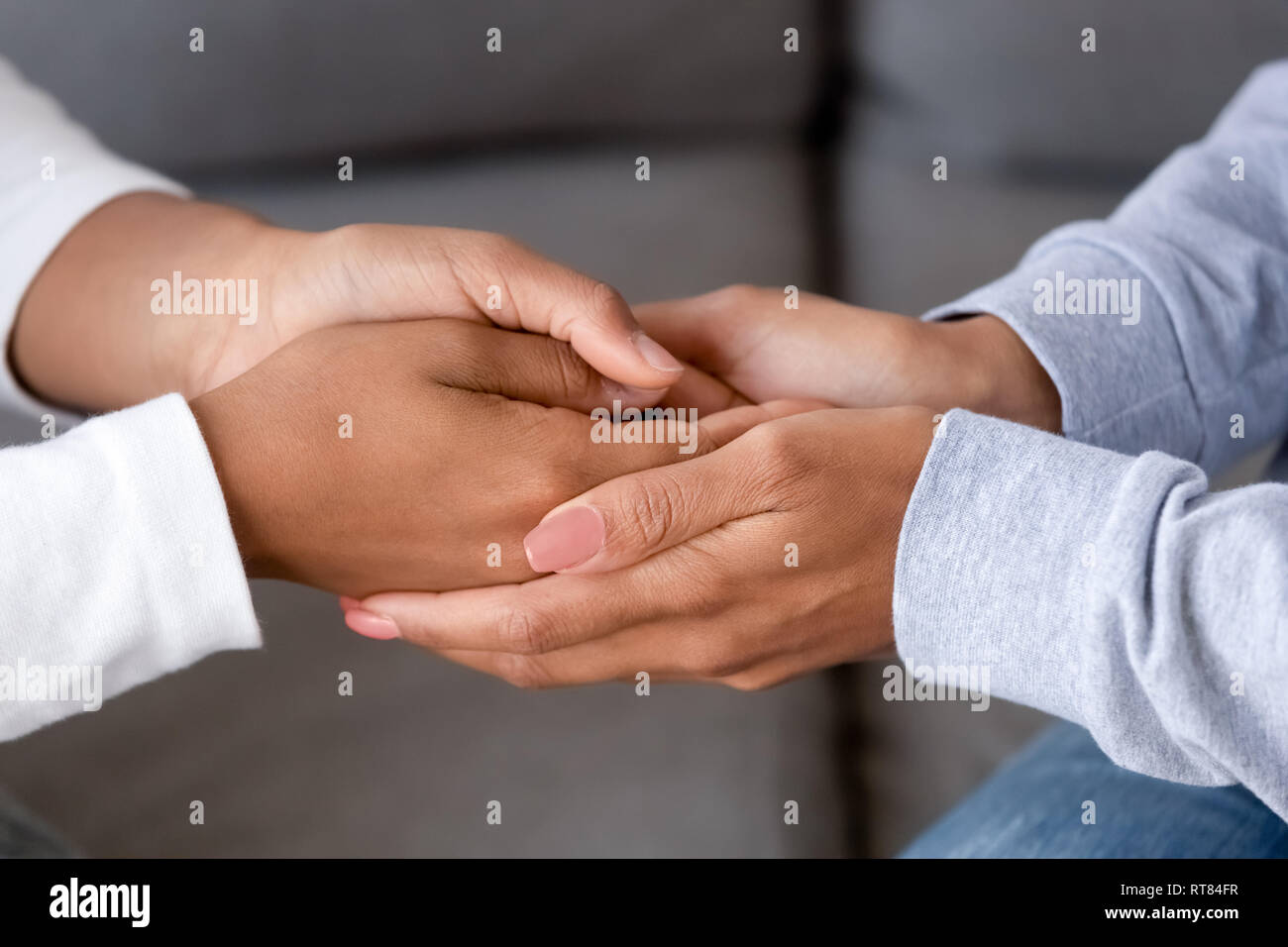 Black mother and daughter holding hands close up Stock Photo - Alamy