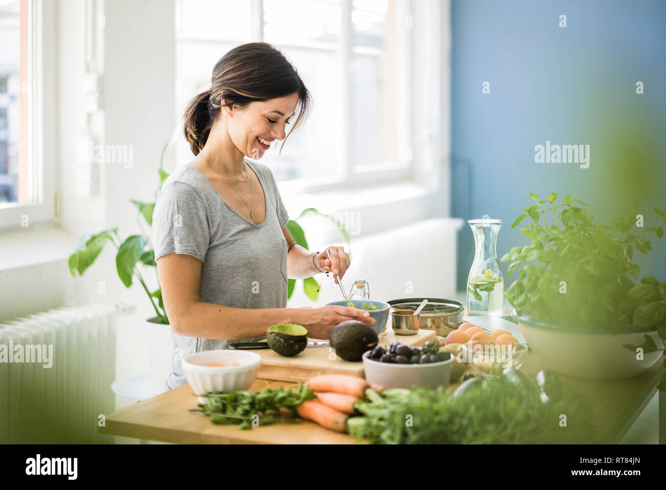 Woman preparing healthy food in her kitchen Stock Photo