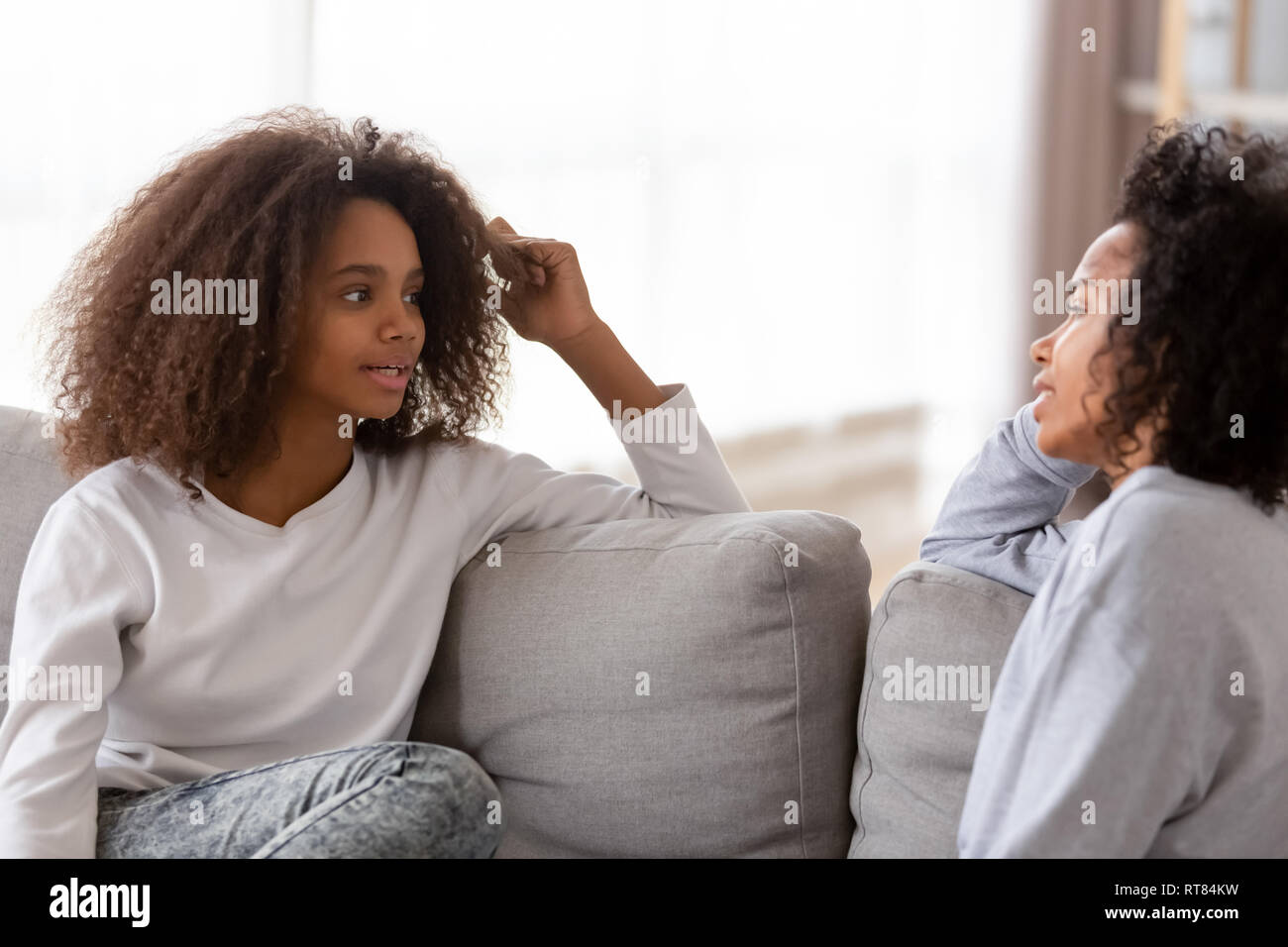 African mother and daughter chatting spending free time at home Stock Photo
