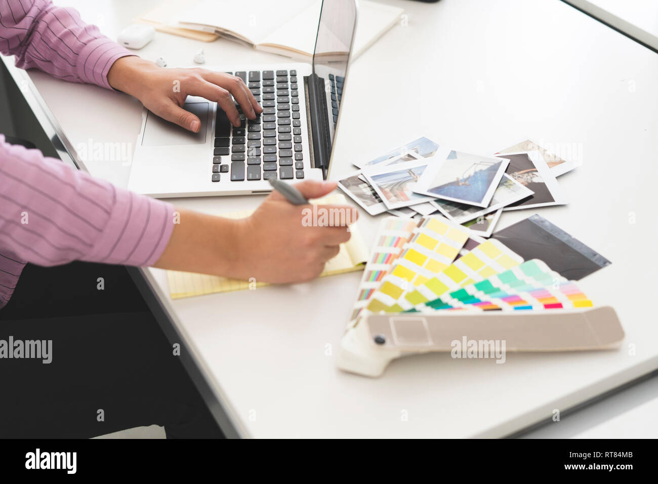 Designer working in office, using laptop, close up Stock Photo