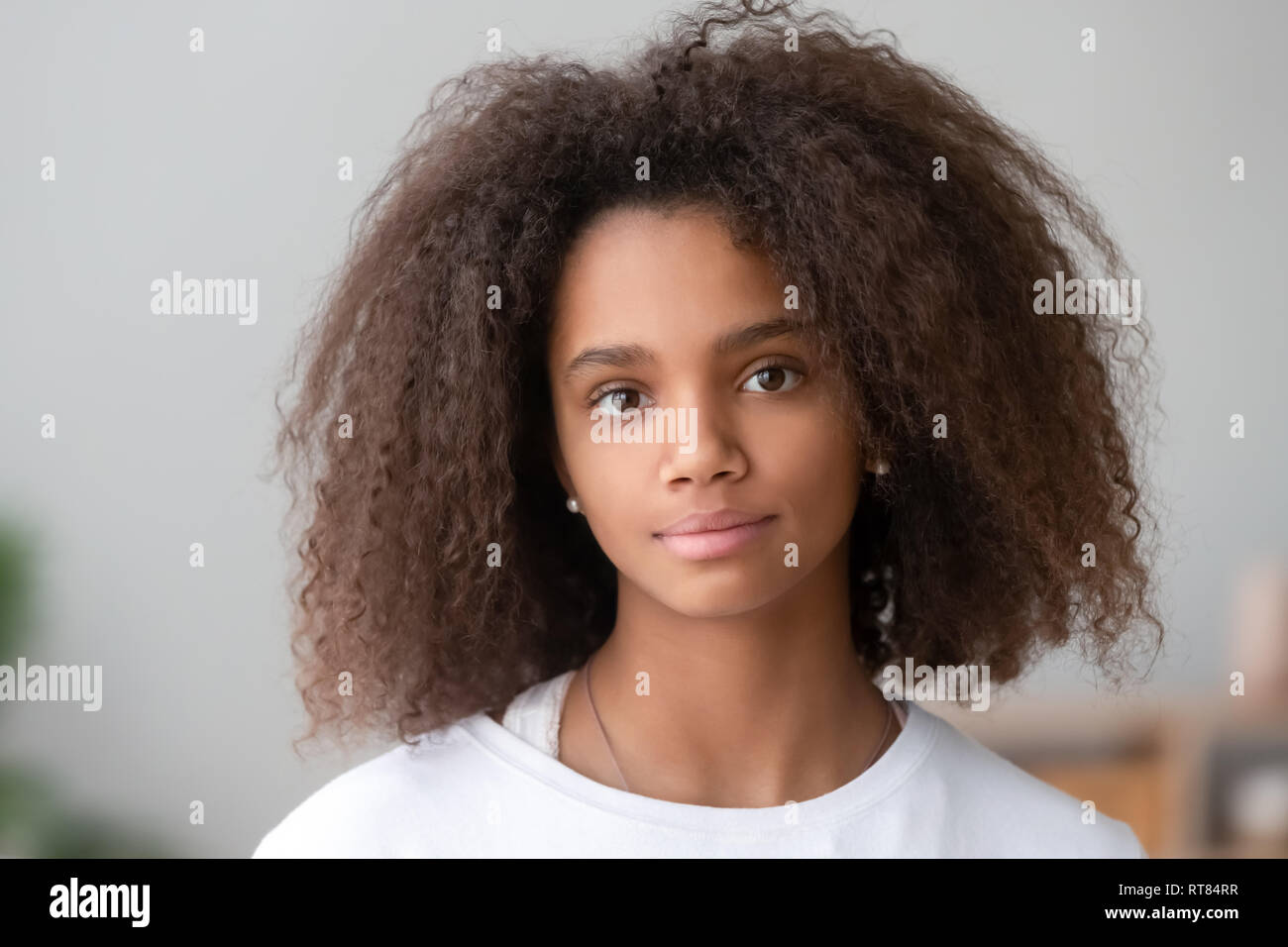 Head shot portrait attractive african teenager girl looking at camera Stock Photo