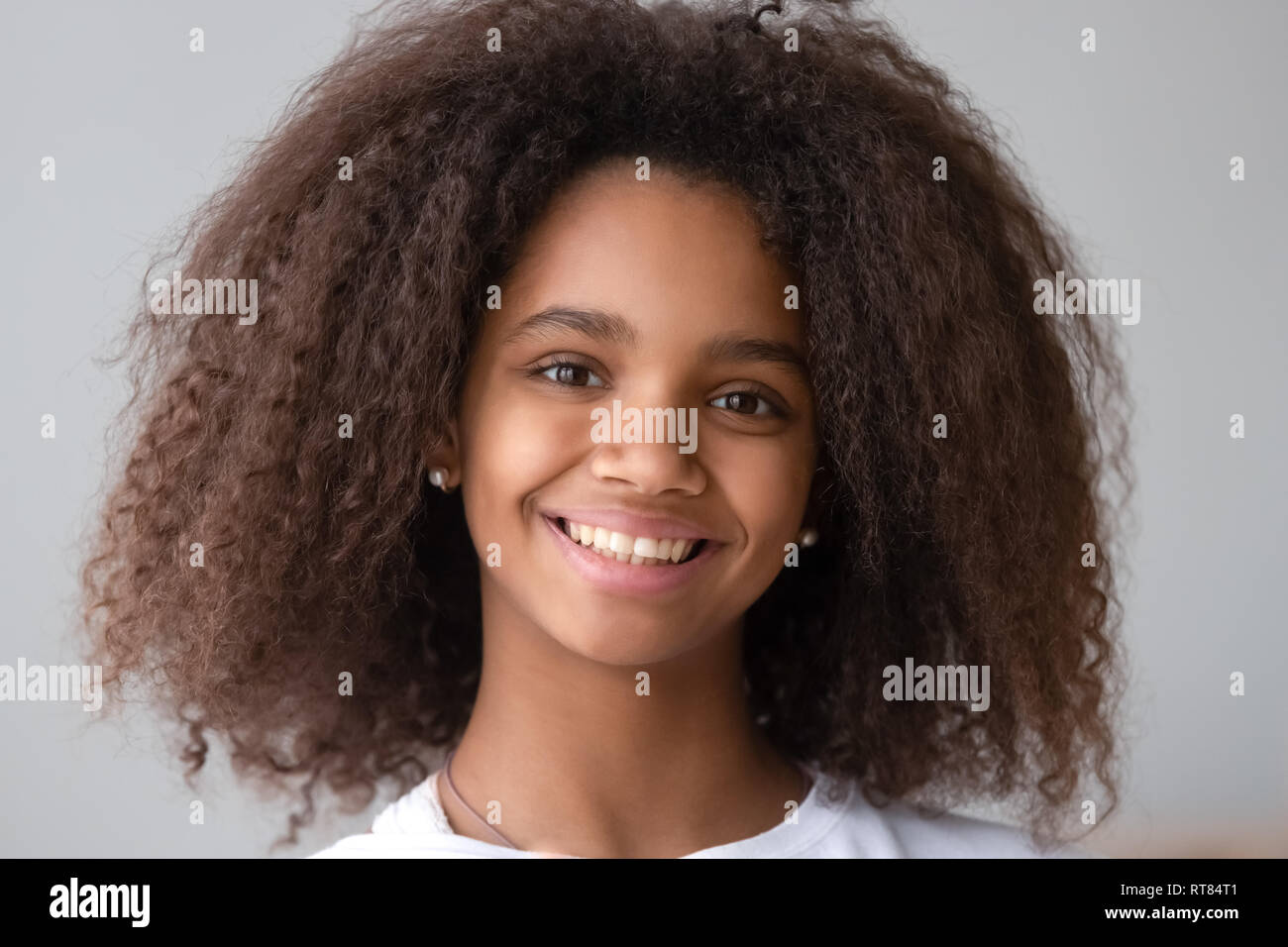 Attractive black teenager girl smiling looking at camera Stock Photo