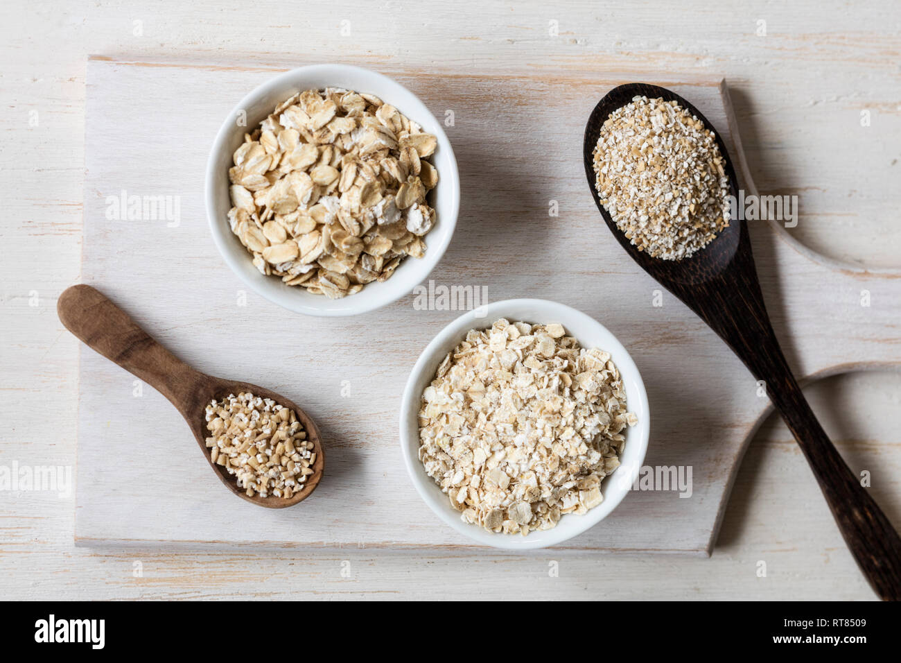 Two variations of oat flakes, oat bran and steel-cut oats Stock Photo