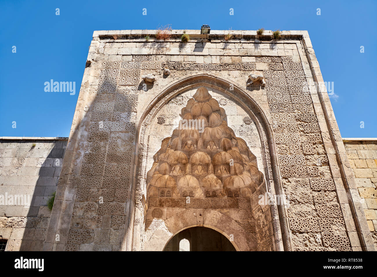 The marble crown gate of the Sifaiye Medrese has a very rich decorative appearance, 1217. Its islamic Muqarnas corbelled vault is made up of a large n Stock Photo