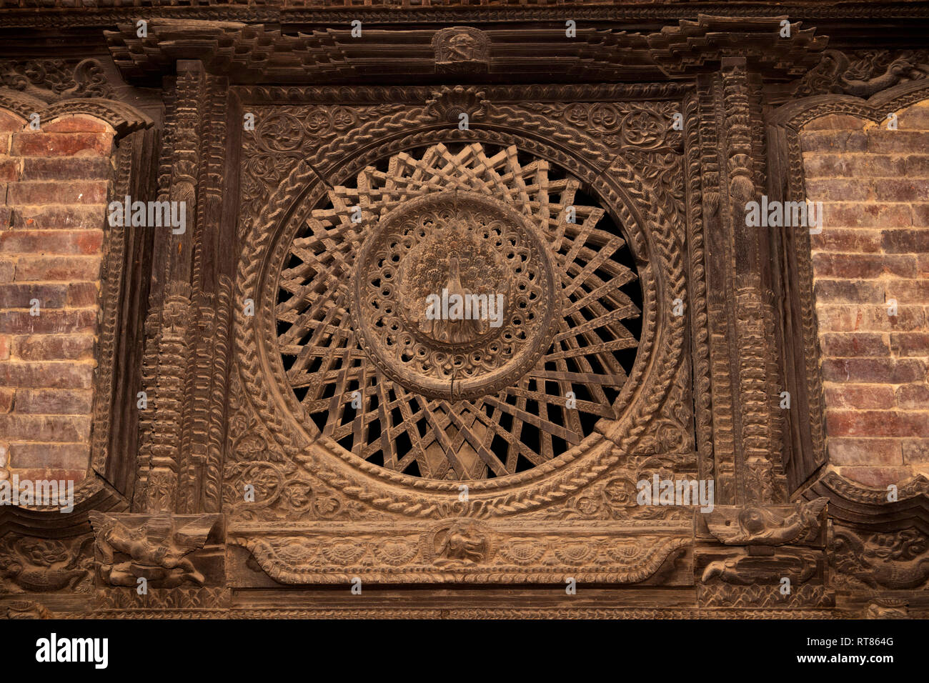 Nepal, Kathmandu Valley, Bhaktapur, Tachupal Tole, Pujari Math, the carved wooden Peacock Window Stock Photo