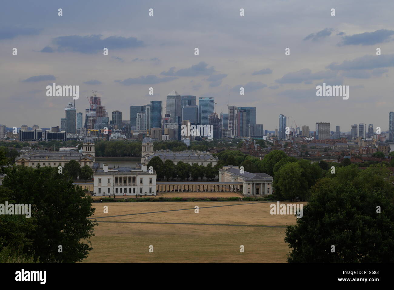 The historical Old Royal Naval College and other modern buildings make up London city skyline as seen from Greenwich in London, United Kingdom. Stock Photo
