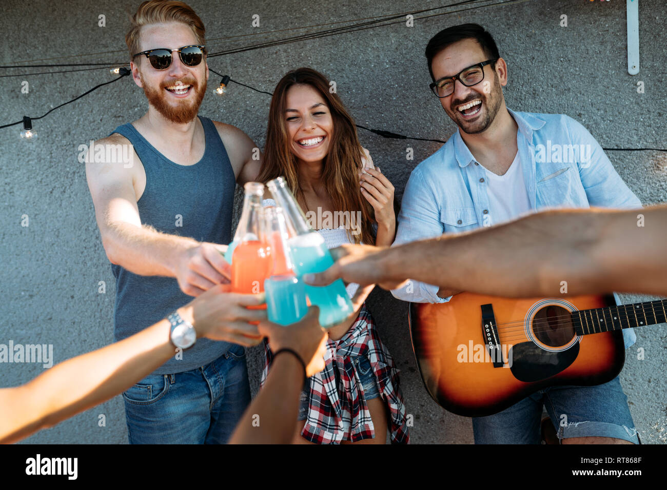 Group of happy friends having party on rooftop Stock Photo