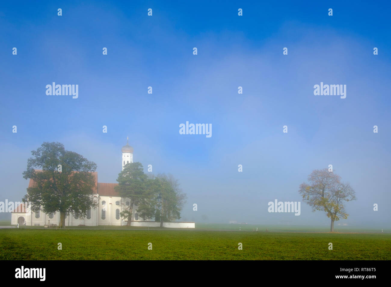 Germany, Bavaria, Schwabia, Schwangau, View to pilgrimage church St. Coloman and fog Stock Photo