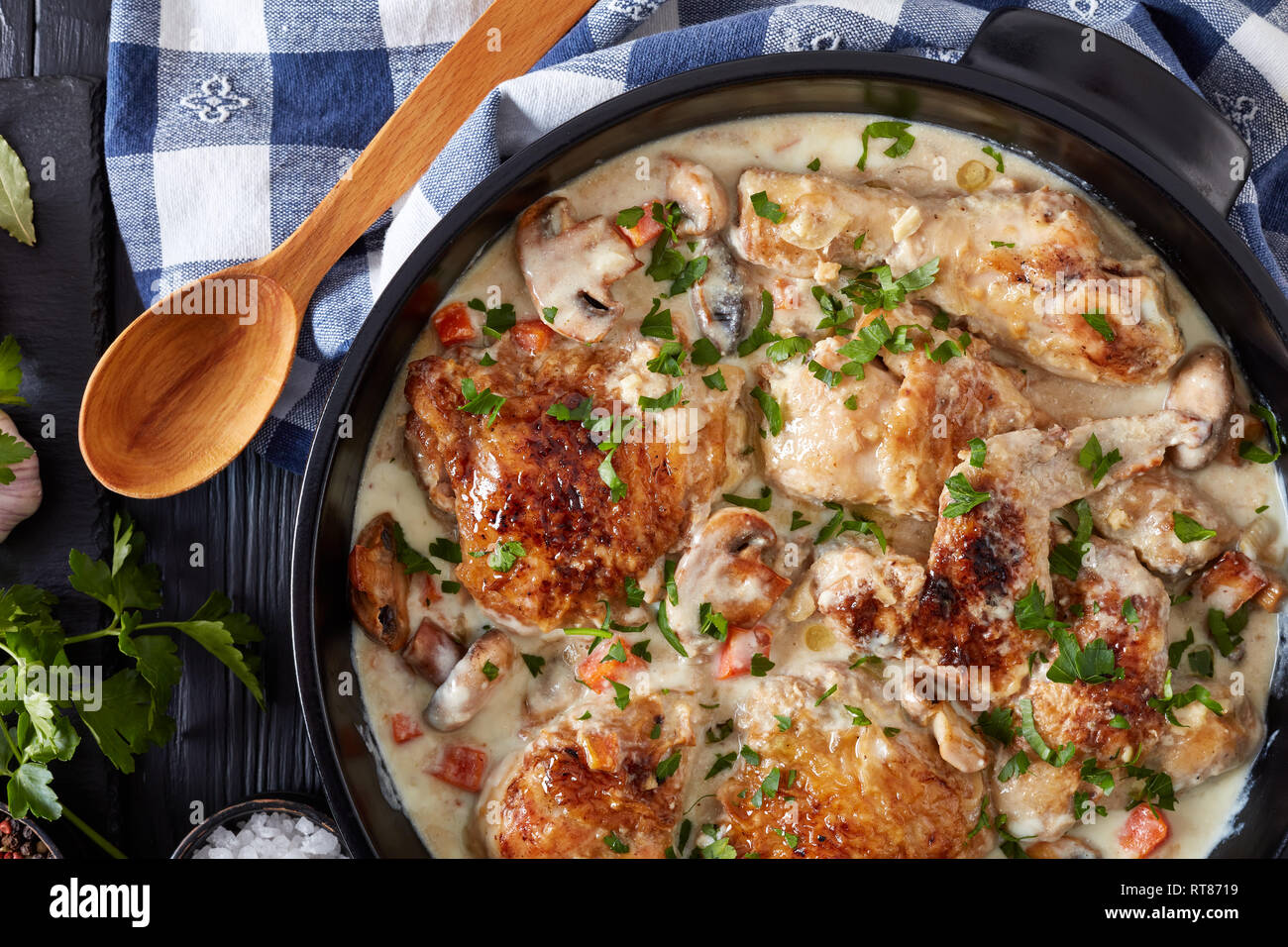 chicken fricassee in a black dutch oven chicken meat browned and