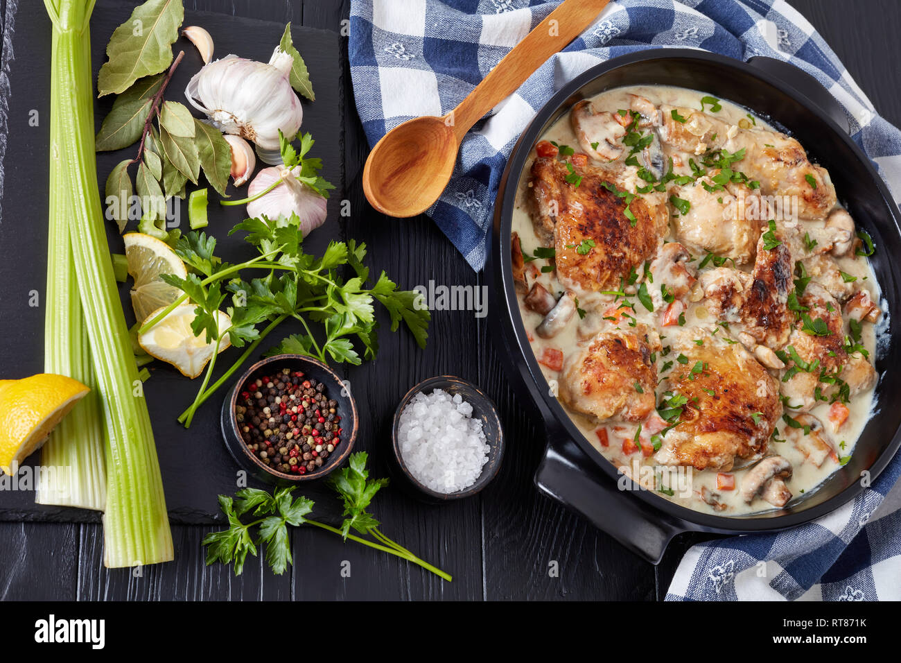 chicken fricassee in a black dutch oven chicken meat browned and braised in white wine creamy