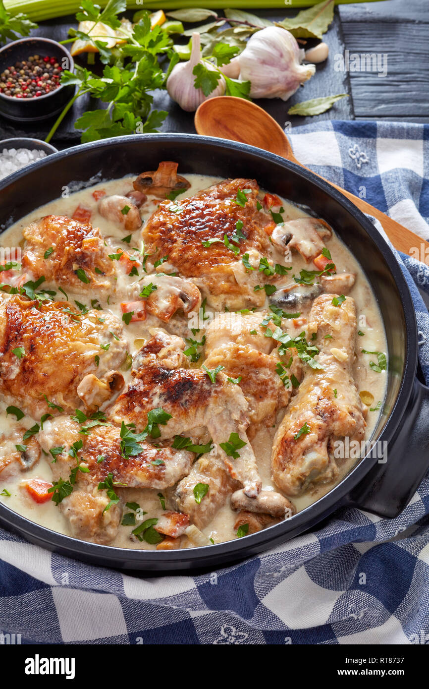 hot chicken fricassee in a black dutch oven chicken meat browned and