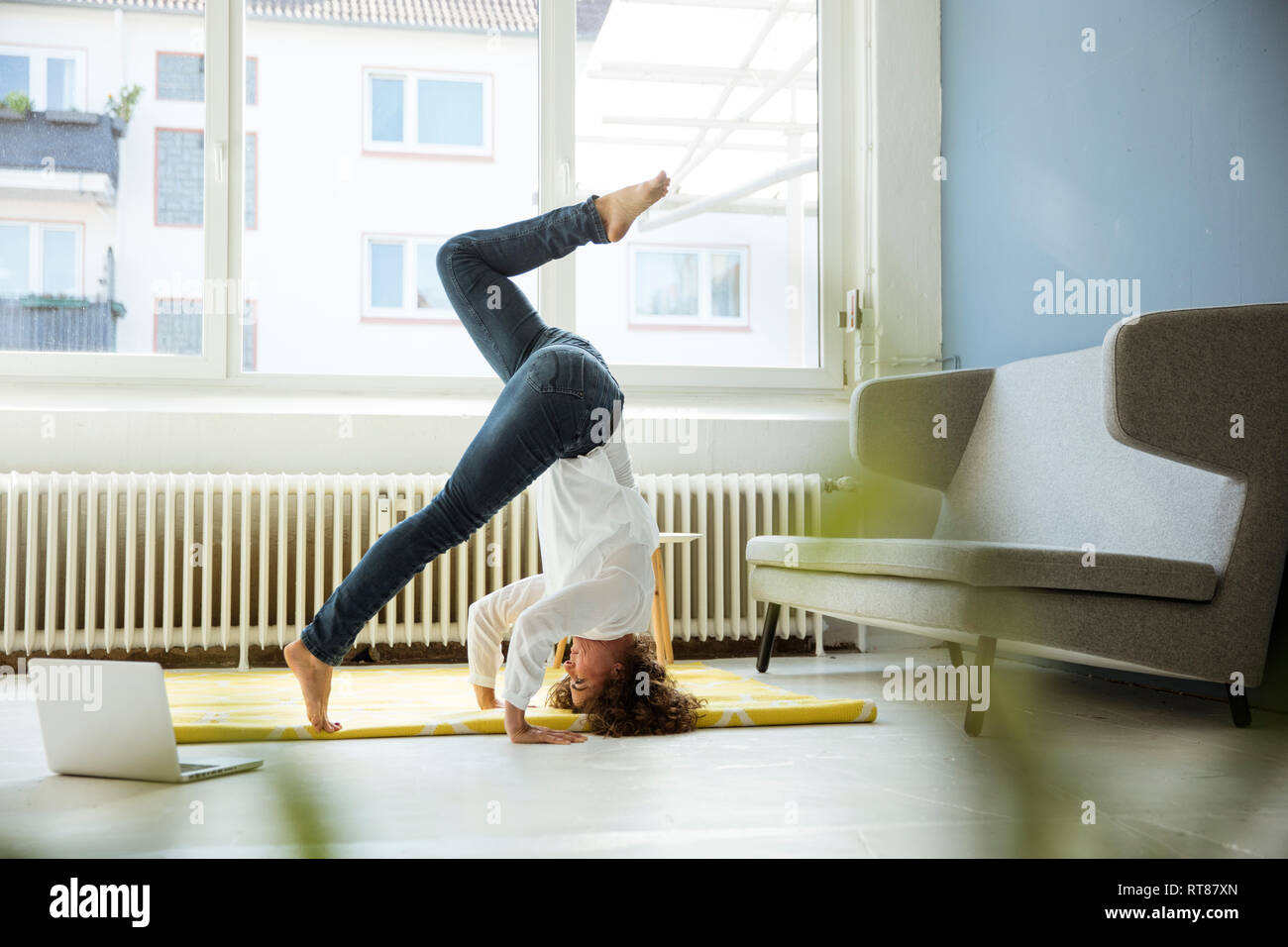 Businesswoman practising yoga on the floor Stock Photo