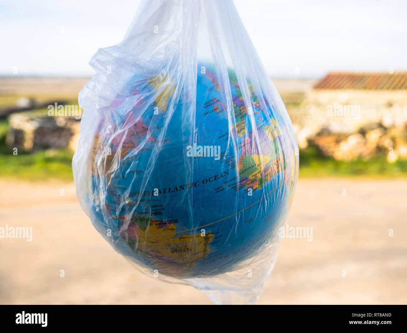 A terrestrial globe or planet Earth inside a plastic bag. Concept of ecology Stock Photo