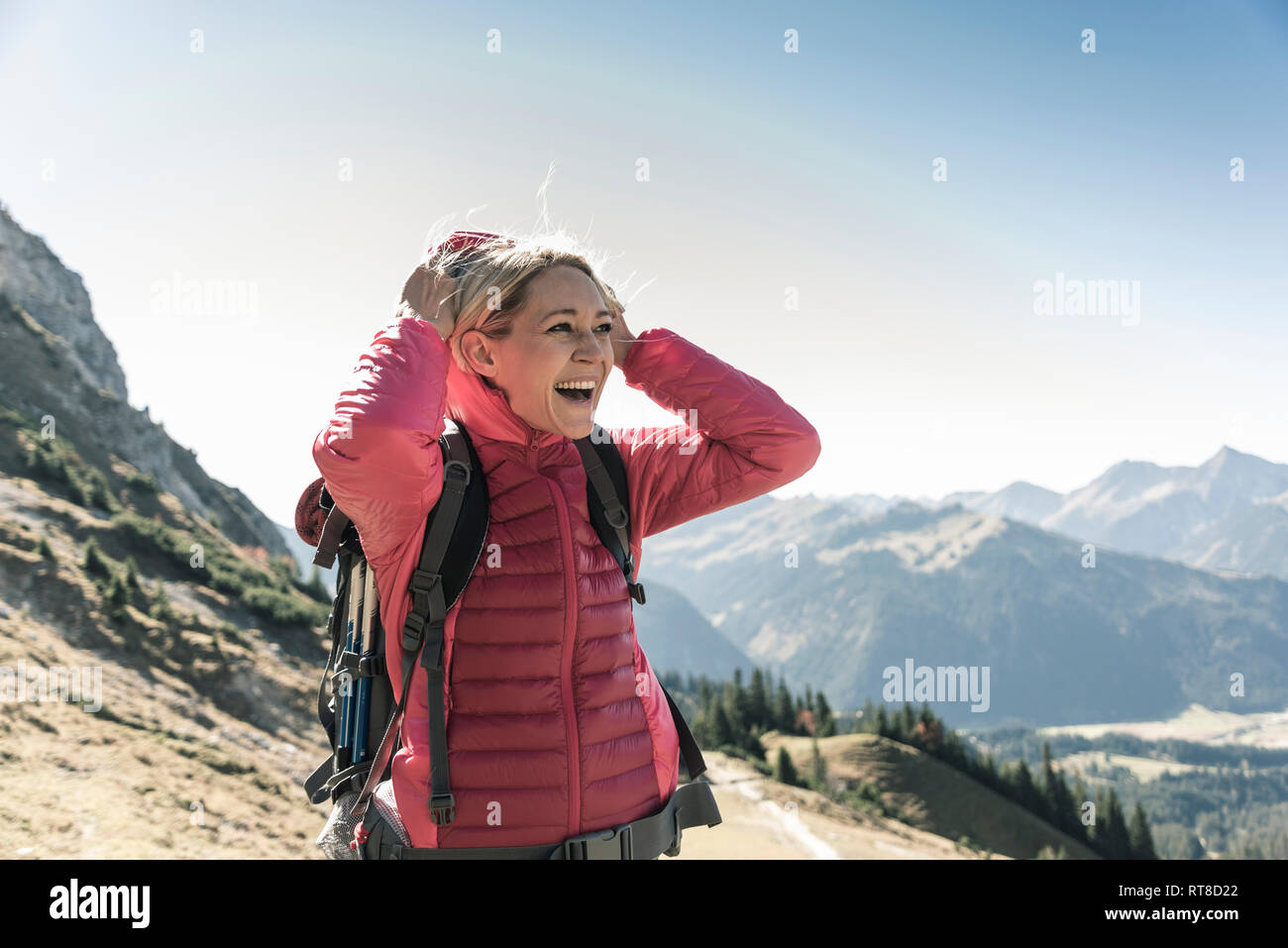 Austria, Tyrol, happy woman on a hiking trip in the mountains enjoying the view Stock Photo