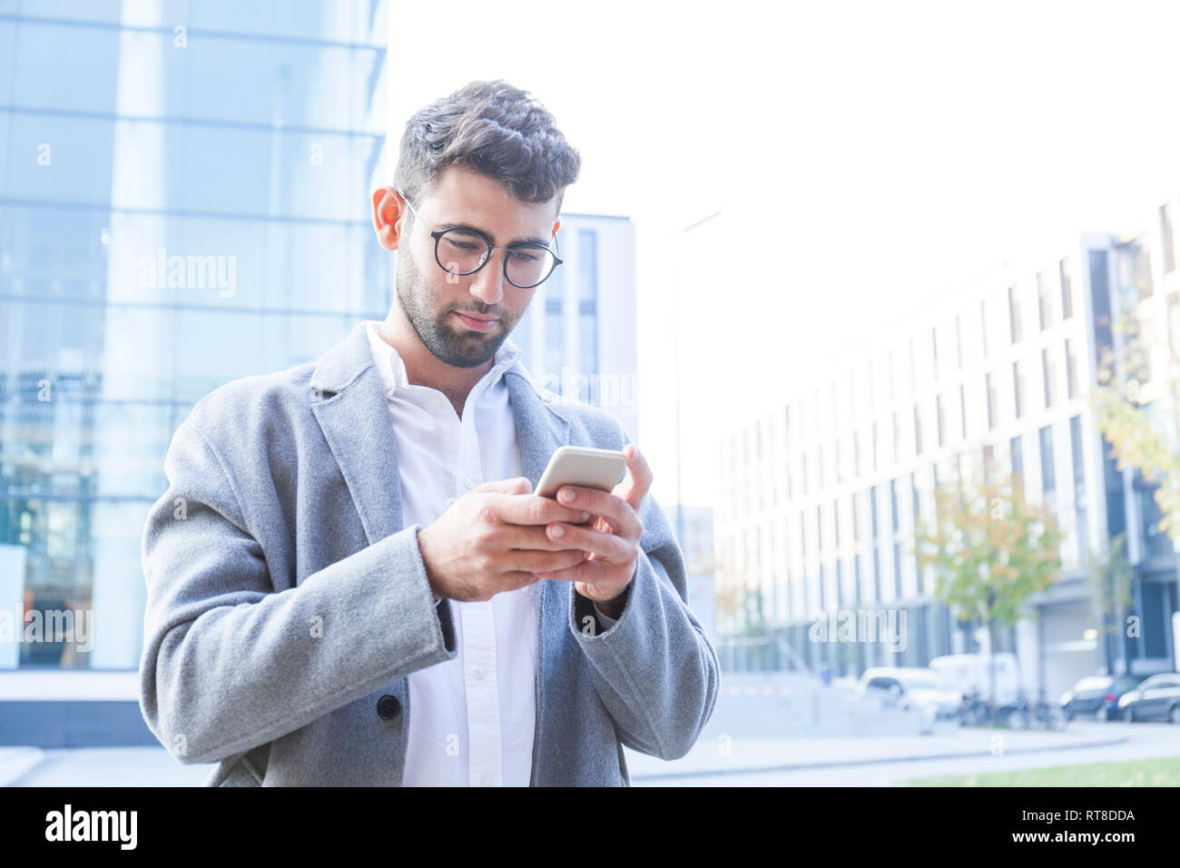 Portrait of young businessman using cell phone Stock Photo