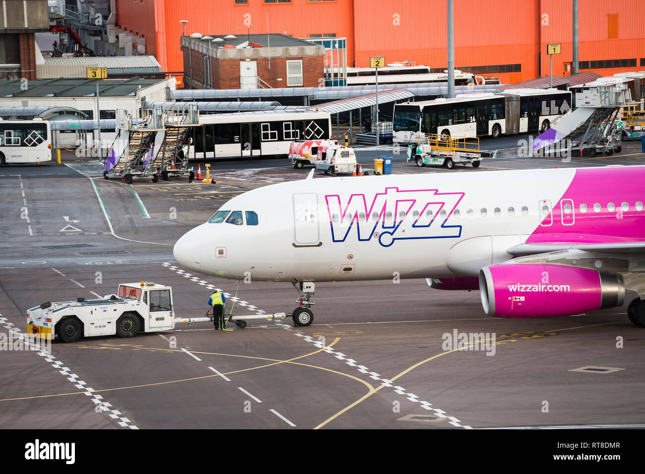 Wizz Air aeroplane being towed with a tug at Luton airport, England. Stock Photo