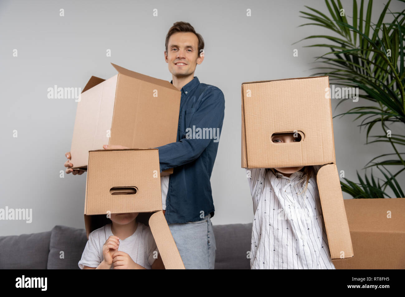 Man with cardboard box, children with boxes on head Stock Photo - Alamy