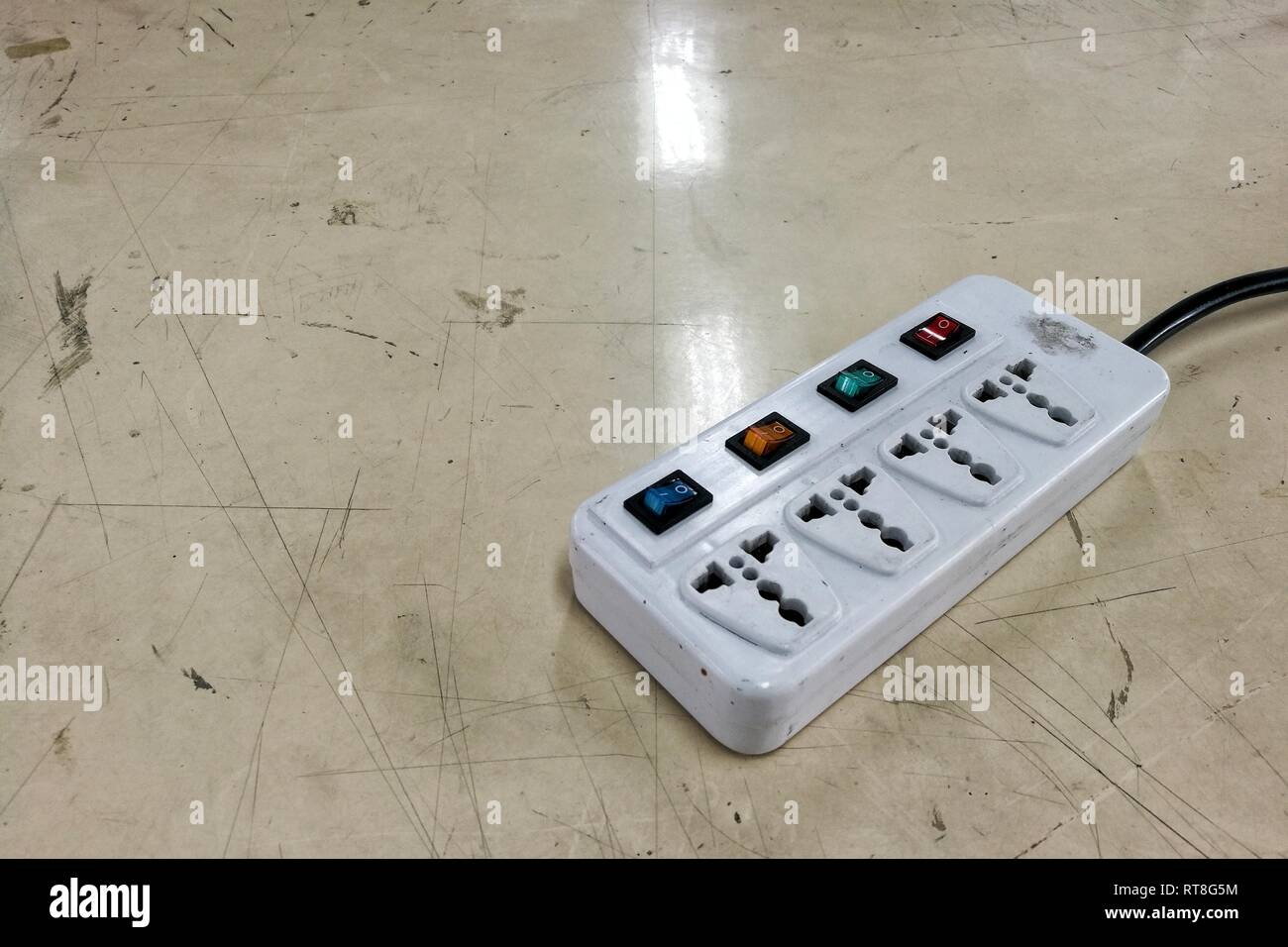 multiple socket plug. old movable electric plug with separate switch for each socket. Stock Photo