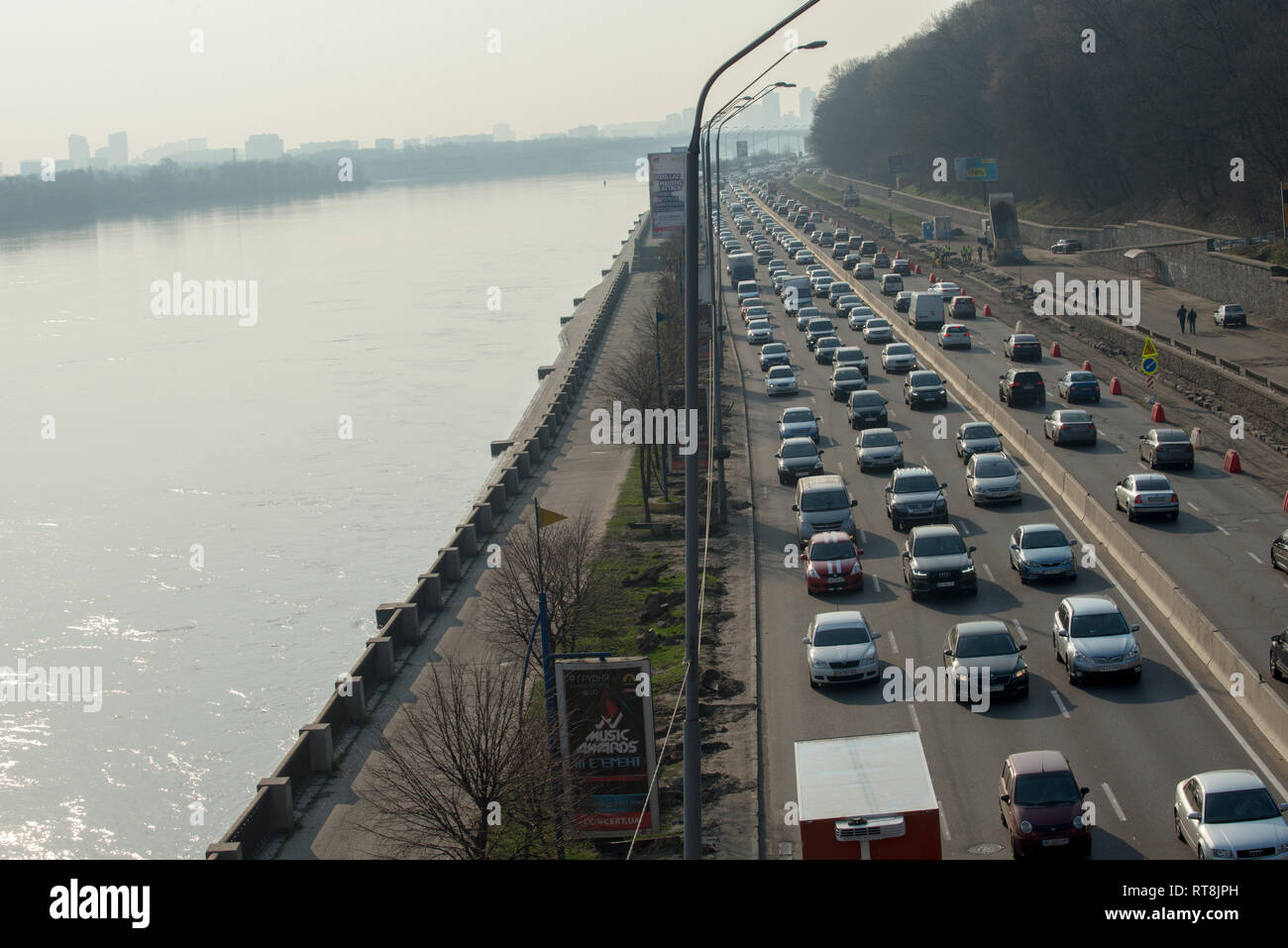 Morning busy traffic by the road along the Dnipro river, Kyiv, Ukraine Stock Photo