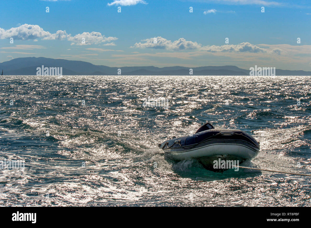 rescue boat behind cruise ship in shimmering water, travel Australia great barrier reef Stock Photo