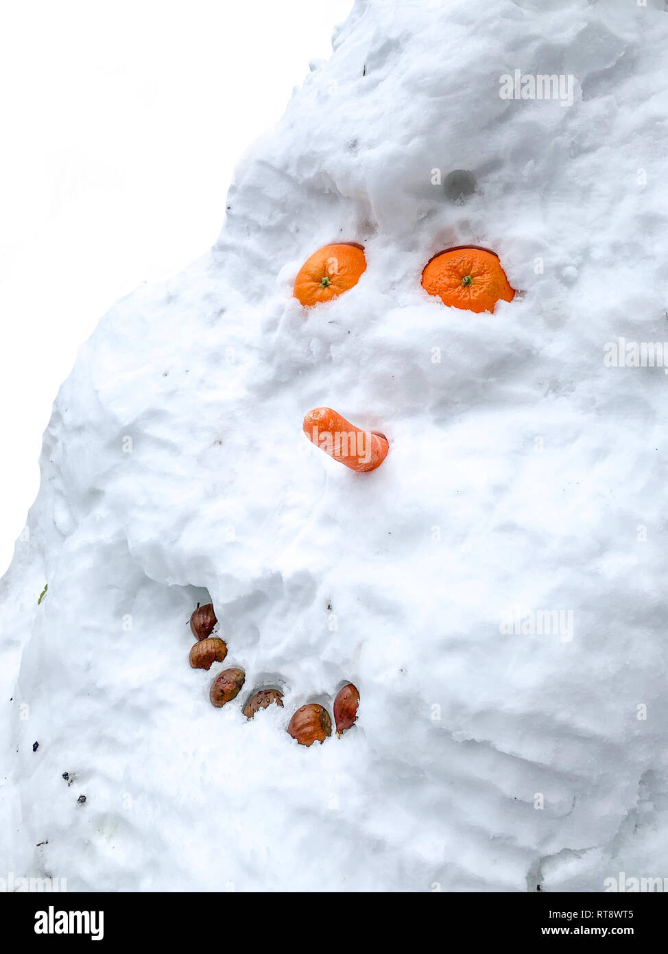 Funny Snowman smiling with orange eyes Stock Photo