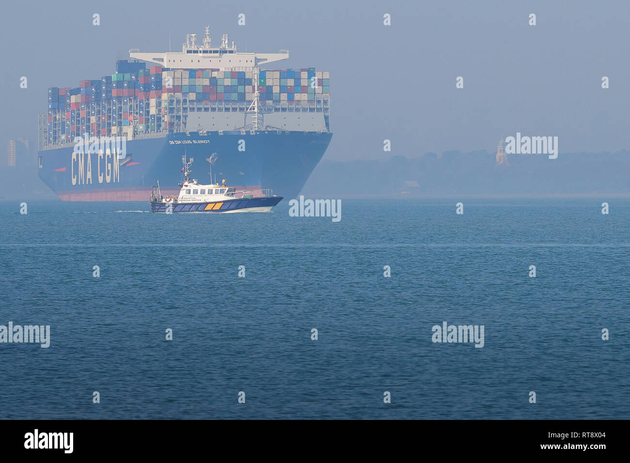 The 400 metre, Ultra-Large Container Ship, CMA CGM LOUIS BLERIOT, Departing The Port Of Southampton, A Waiting Pilot Launch In The Foreground. UK. Stock Photo