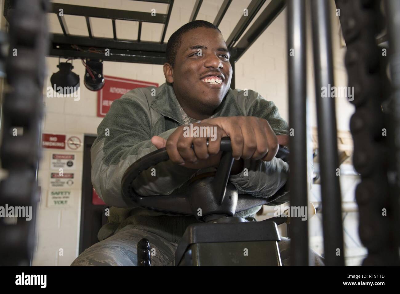 Airman Anthony Lemarc Cole Jr., a traffic management specialist, 108th Logistics Readiness Squadron, poses for a photo while seated on a forklift at Joint Base McGuire-Dix-Lakehurst, N.J., Feb. 4, 2019. Cole said what he enjoys most about traffic management is that he is hands-on at all times. Stock Photo