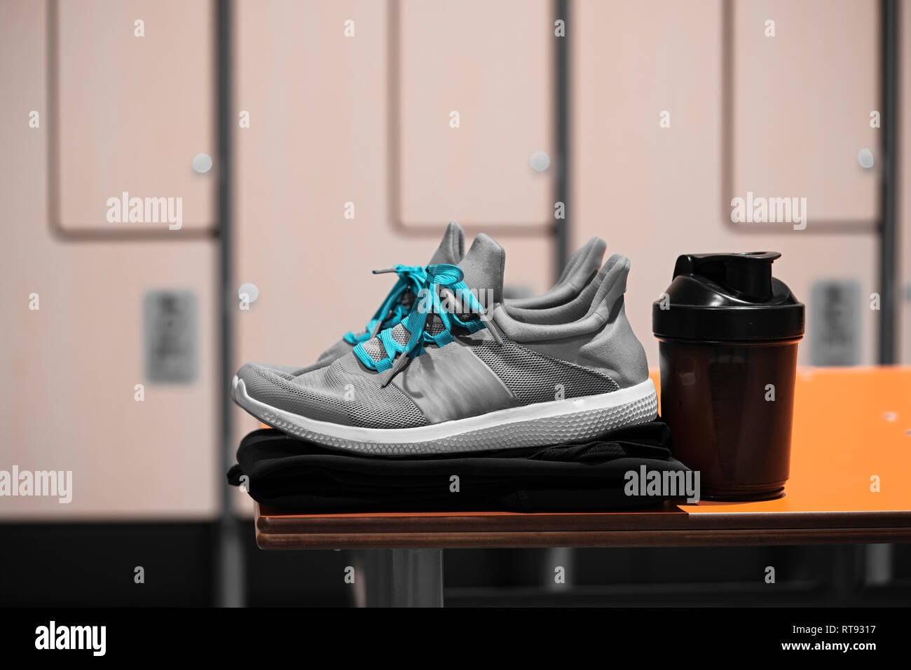 Close up of sports shoes, sportswear and sport water bottle in gym locker room. Concept of active lifestyle, gaining muscles or loosing fat. Sport equ Stock Photo