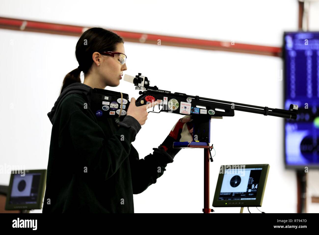Sarah Leininger from Fort Mill, South Carolina, takes a deep breath before firing at the Day 1 Sporter Finals during the U.S. Army Junior Rifle National Championships at Fort Benning, Georgia January 25, 2019. The three-day, invitation-only event had the youth athletes compete side by side for top individual and team honors in three-position smallbore, sporter rifle and precision rifle. At the end of the competition, Leininger was awarded the title, 2019 Junior National Sporter Champion, with a score of 1131 and 41X. Stock Photo