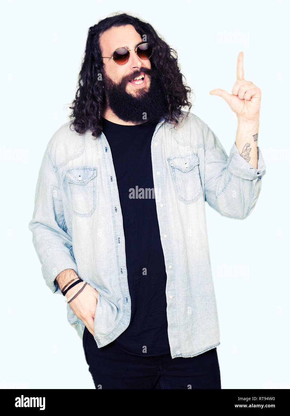 Young Hipster Man With Long Hair And Beard Wearing Sunglasses