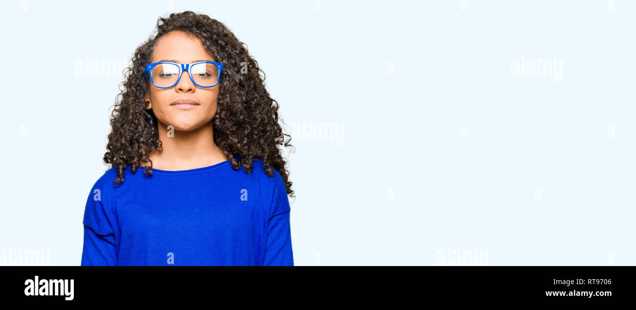 Young Beautiful Woman With Curly Hair Wearing Glasses With Serious