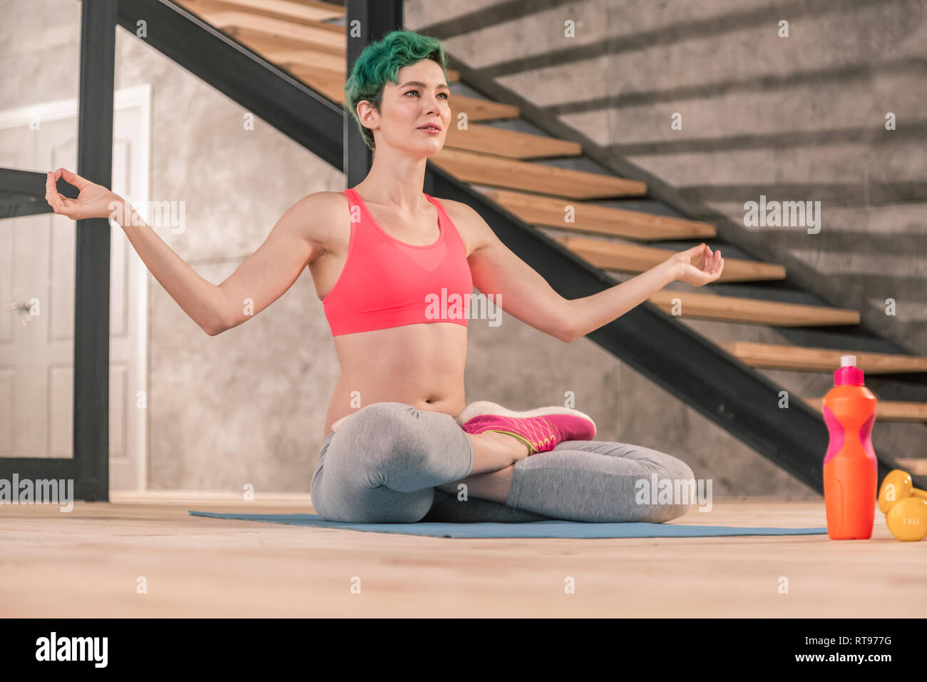 Appealing woman meditating after morning yoga at home Stock Photo